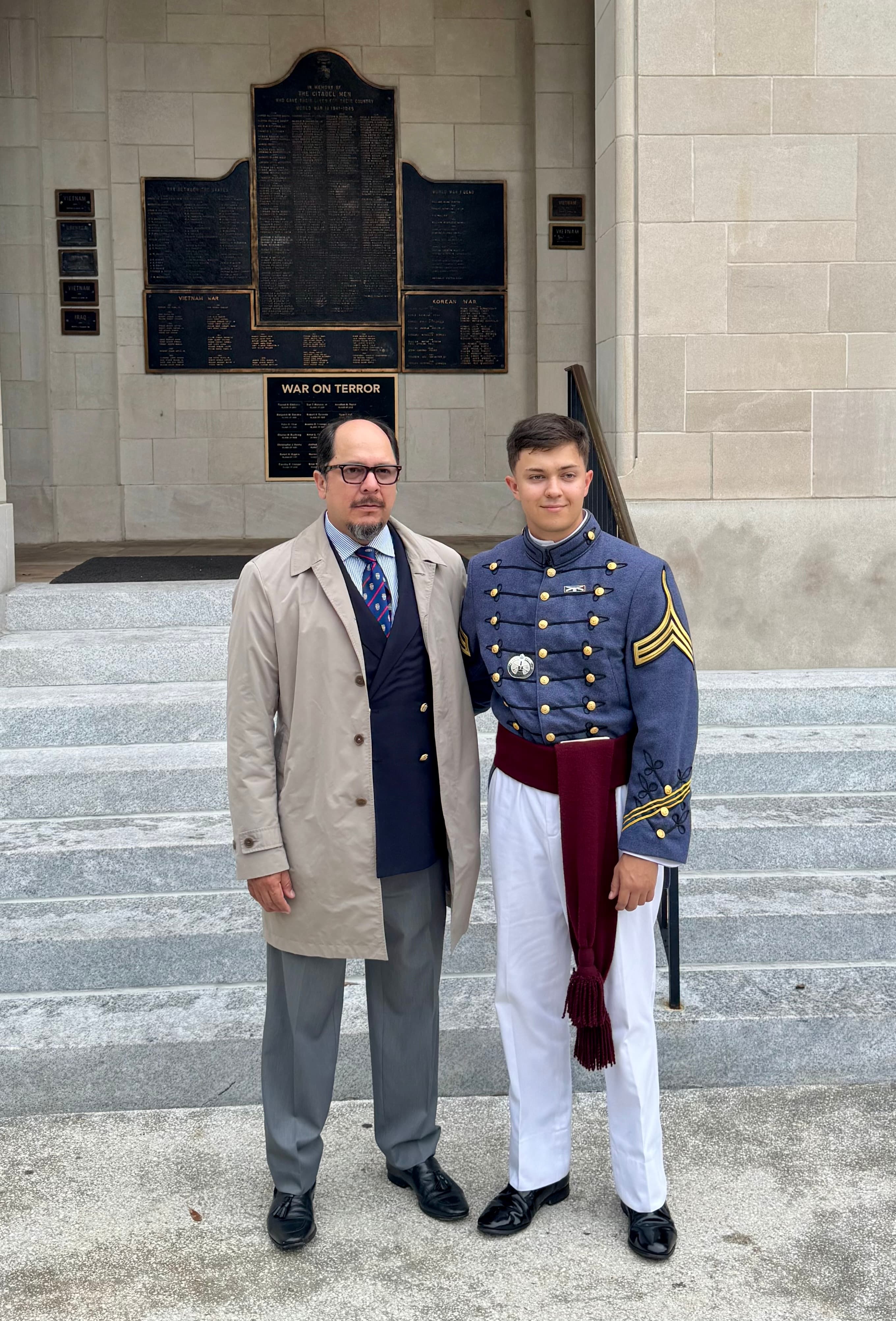 A cadet and a family member stand beside the War on Terror memorial plaques at The Citadel.